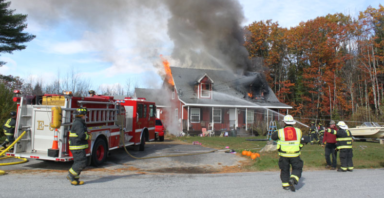 Firefighters battle a blaze Sunday at 18 Henderson Drive in Buxton. 
Photo courtesy Dan Grover
