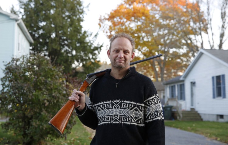 Mark Mayone of South Portland holds the .410 double-barreled shotgun that he says he could not lend to his friend's son without a background check if Question 3 passes. He plans to vote against Question 3, largely because of that requirement.