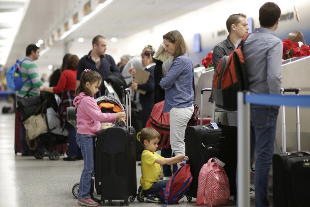 Last year's Thanksgiving holiday travelers at Miami International Airport wait for security screening. This year the TSA has increased staffing and encouraged the use of PreCheck.