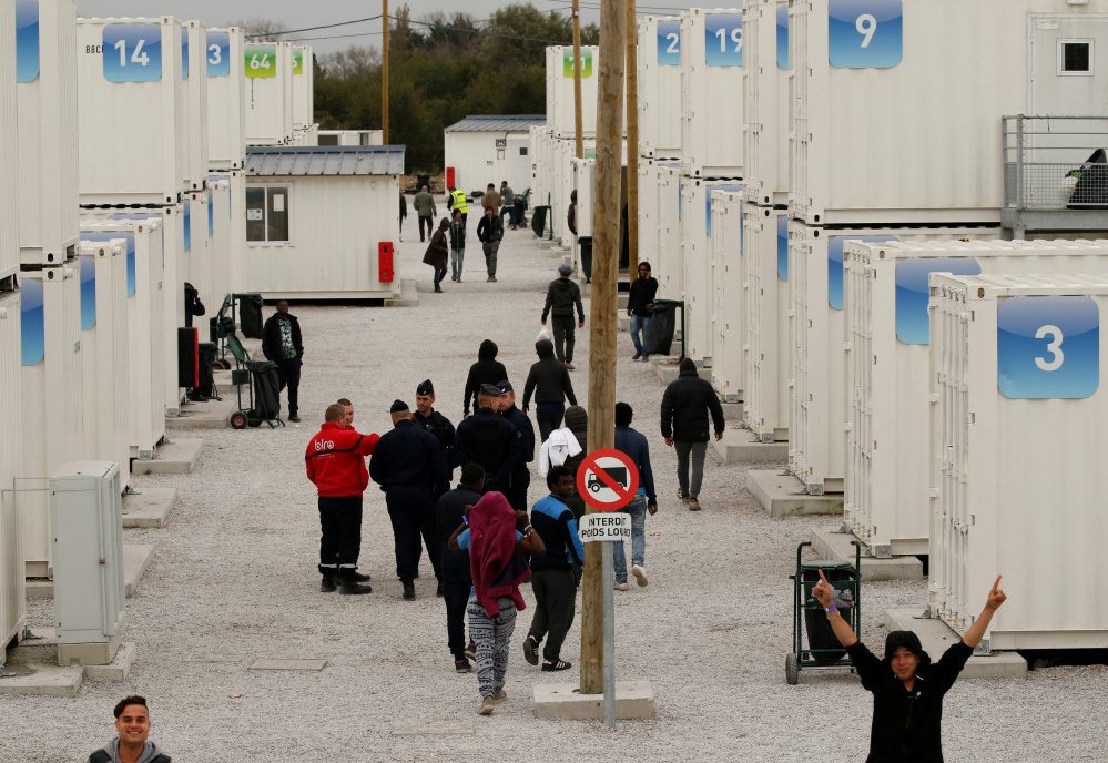 Temporary containers were used to house minors while they stayed in a migrant camp in Calais, France. All unaccompanied children were bused out of the camp Wednesday.