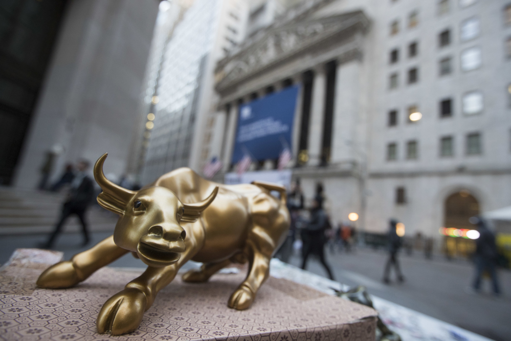 A miniature reproduction of Arturo Di Modica's "Charging Bull" sculpture sits on display at a street vendor's table outside the New York Stock Exchange in lower Manhattan. Stocks lost ground again Thursday over uncertainty in the presidential election.