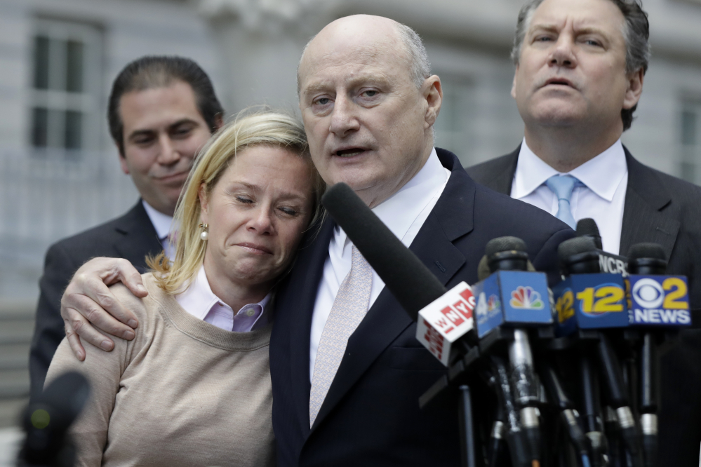 Bridget Anne Kelly, left, former deputy chief of staff for New Jersey Gov. Chris Christie, is held by her lawyer Michael Critchley while talking to reporters after she was found guilty on all counts in the George Washington Bridge traffic trial at Martin Luther King, Jr., Federal Court on Friday in Newark, N.J.