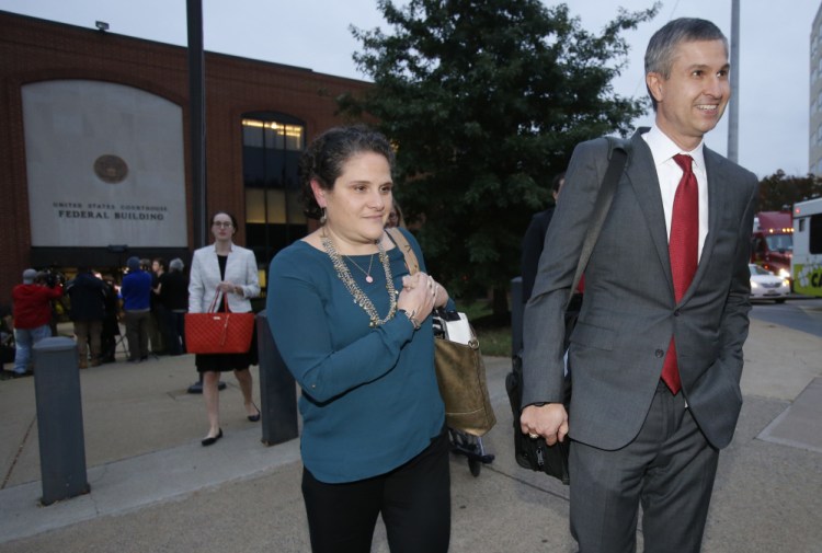 University of Virginia administrator Nicole Eramo, center, leaves federal court with her attorney Tom Clare, right, after closing arguments in her defamation lawsuit against Rolling Stone magazine in Charlottesville, Va. A jury Friday ruled against the magazine.