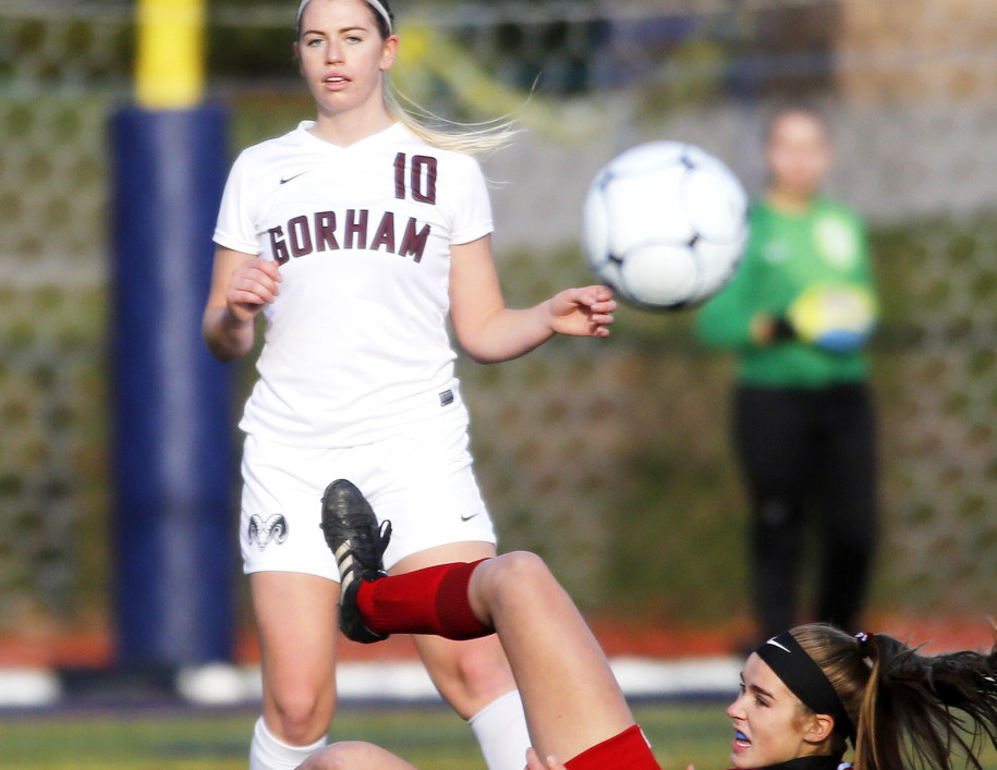 Gorham High's Meghan Perrin clears the ball after colliding with Eliza Roy of Camden Hills during the Class A girls' soccer championship at Fitzpatrick Stadium on Saturday. (Photo by Derek Davis/Staff Photographer)