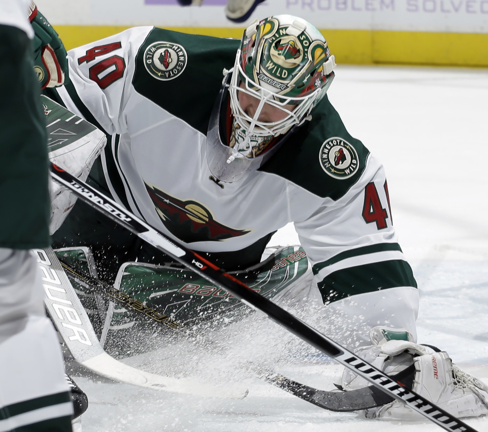 Minnesota Wild goalie Devan Dubnyk makes a save Saturday against Colorado. Dubnyk stopped 31 of the 32 shots he faced but was outdone by Calvin Pickard who made 32 saves in the Avalanche's 1-0 victory.