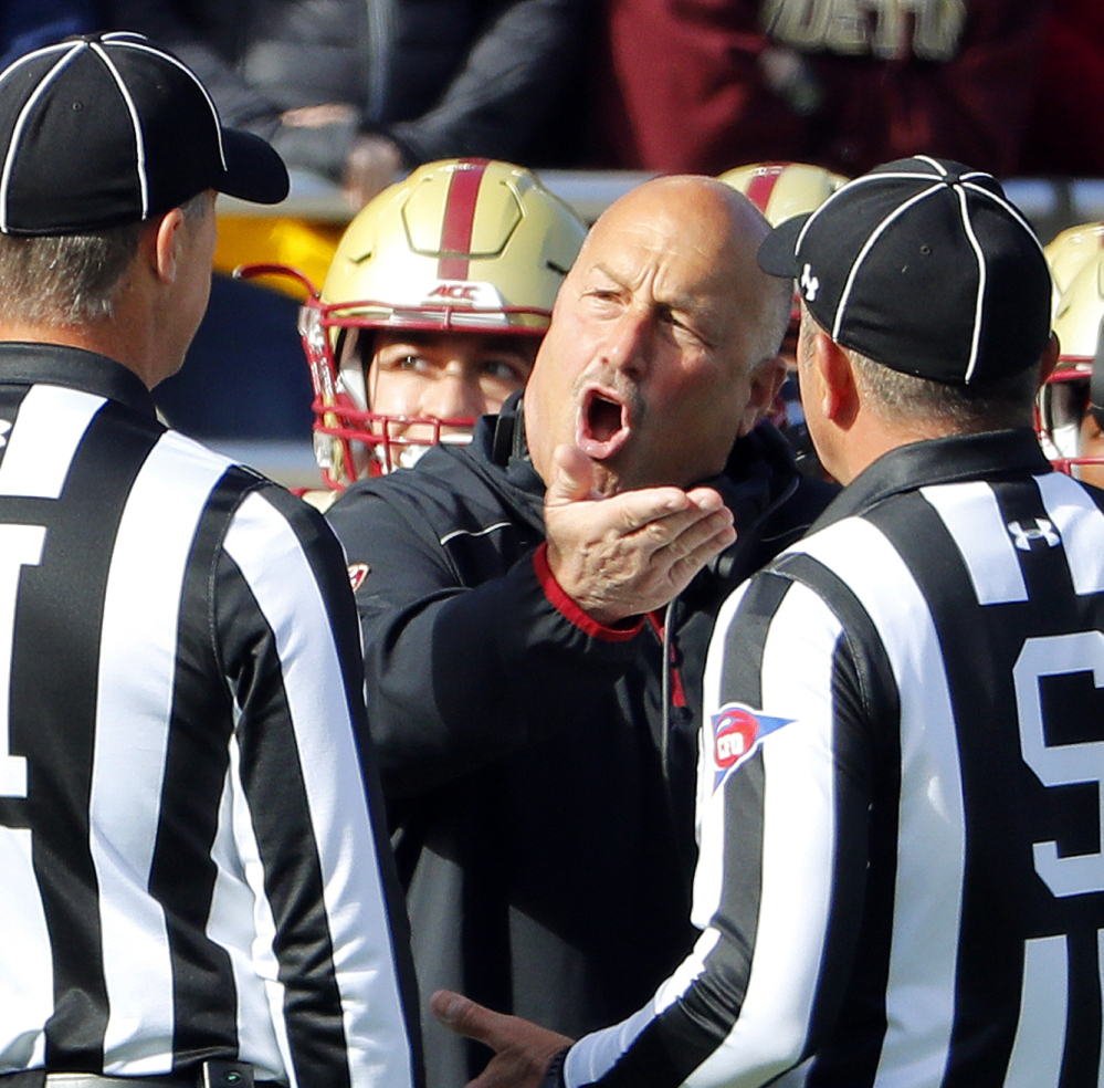 Boston College Coach Steve Addazio, center, argues with officials during Saturday's game in Chestnut Hill, Mass. Addazio had plenty to be upset about as his Eagles were crushed by No. 5 Louisville 52-7 to fall to 1-5 in Atlantic Coast Conference play.