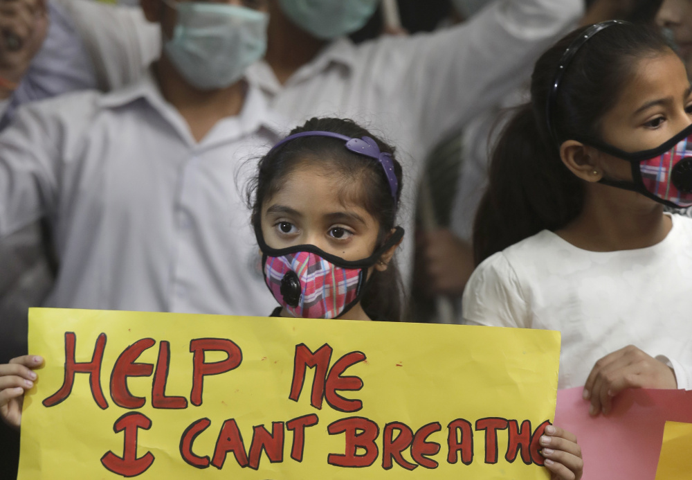 An Indian girl holds a banner during a protest in New Delhi on Sunday.
