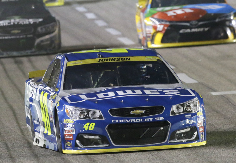 Jimmie Johnson drives into turn one ahead of other drivers during the NASCAR Sprint Cup Series race Sunday at Texas Motor Speedway in Fort Worth, Texas.