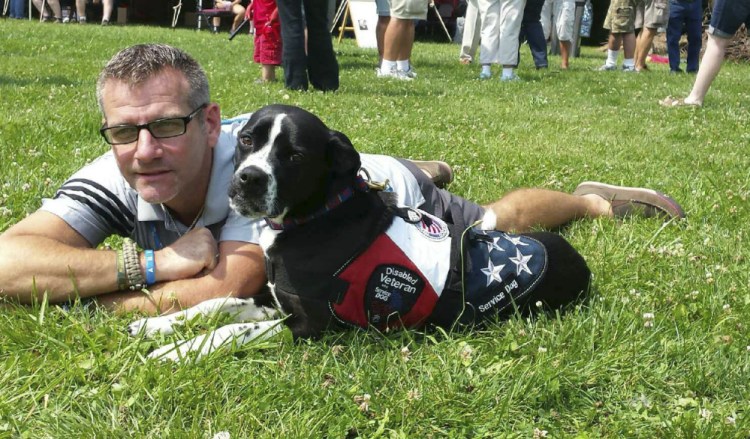 Richard Brewer in 2015 with his service dog, Anka.