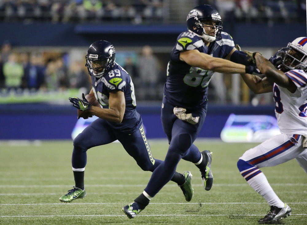 Seattle's Doug Baldwin gets a block from Jimmy Graham and runs for yardage in the first half Monday night in Seattle. The Seahawks won 31-25.
