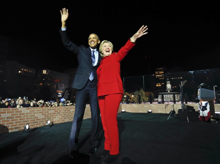 President Barack Obama waves on stage with Democratic presidential candidate Hillary Clinton during a rally at Independence Hall in Philadelphia Monday.