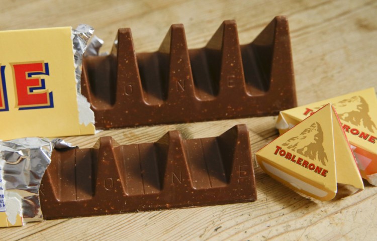 Toblerone Swiss chocolate bars show the new style, front, and the traditional style. Mondelez International, based in Illinois, says the move aims to meet pricing targets by Poundland and other discount retailers in Britain.