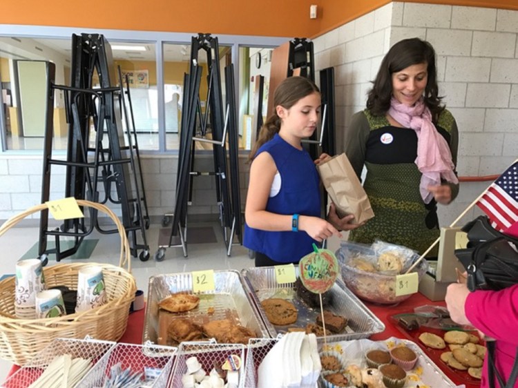 Naila Wissa and her daughter, fifth-grader Nora Grace Monaghan, man the treat table at East End Elementary School on Munjoy Hill.    Peggy Grodinsky/Food Editor
