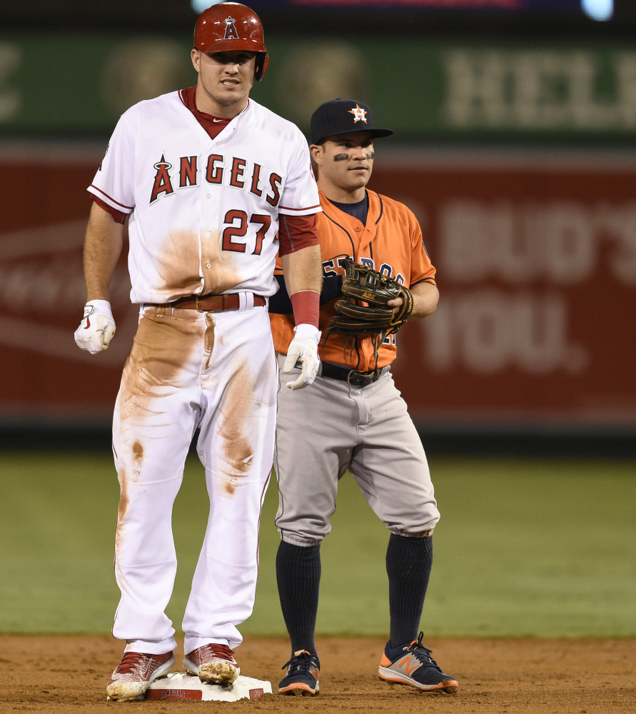 Los Angeles Angels' Mike Trout, left, stands on second after stealing the base as Houston Astros second baseman Jose Altuve, right, looks on during the first inning of a baseball game in Anaheim, Calif., Friday, Sept. 30, 2016. (AP Photo/Kelvin Kuo)