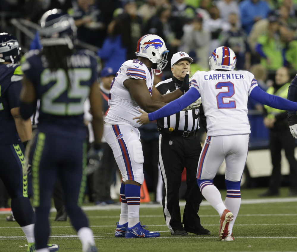 Kicker Dan Carpenter of the Buffalo Bills complains to referee Walt Anderson after being run into recklessly by Richard Sherman of Seattle. Only an offside call was made.