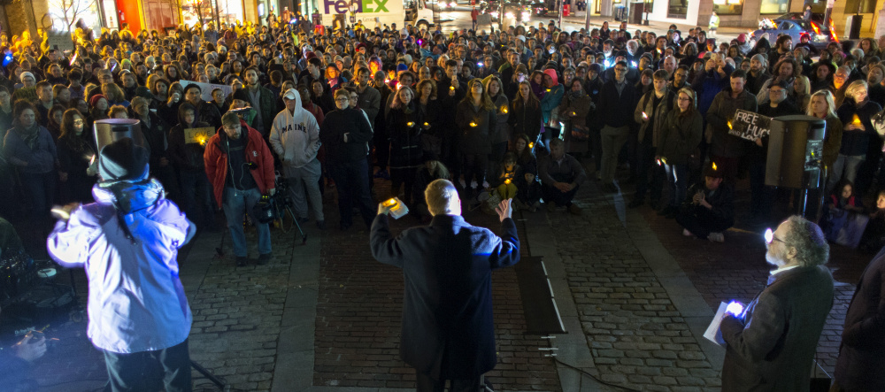 The Rev. Benjamin Shambaugh of St. Luke's Cathedral in Portland addresses hundreds of participants in a unity vigil in Monument Square in Portland on Wednesday.