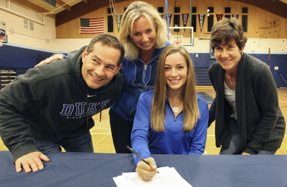 Lily Posternak of York, who will play field hockey at Duke, is joined Wednesday by her parents, Dan and Kristin, and York Coach Barb Marois as she signs her letter of intent.