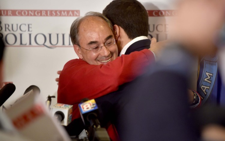 U.S. Rep. Bruce Poliquin hugs son Sam at Dysart's Restaurant in Bangor after defeating Emily Cain on Tuesday. His decisive victory could point to a growing conservatism in the district.