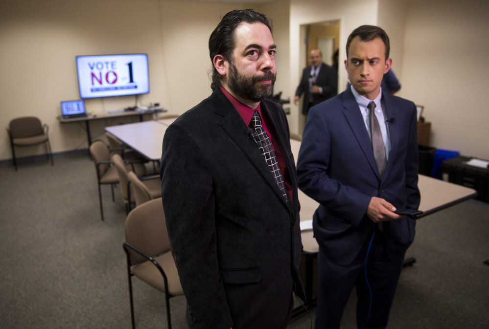 Scott Gagnon, left, of Mainers Protecting Our Youth and Communities stands with Dustin Wlodkowski of WCSH-TV at the Vote No on 1 watch party Tuesday night at the Day One substance abuse center in South Portland.