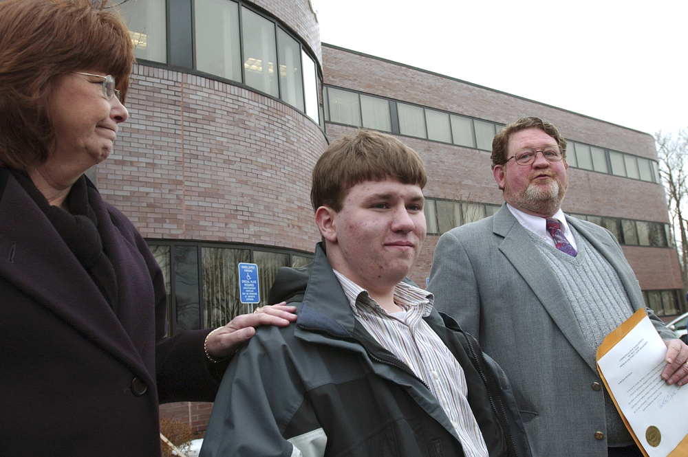 Patrick Holland stands with his adoptive parents, Rita and Ron Lazisky, after his adoption was finalized at the Norfolk County Probate Court in Canton, Mass., in 2005. Holland was granted a ground-breaking "divorce" from his birth father, Daniel Holland, following his conviction in the murder of Patrick's birth mother. The state Supreme Judicial Court heard arguments Thursday in the killing.