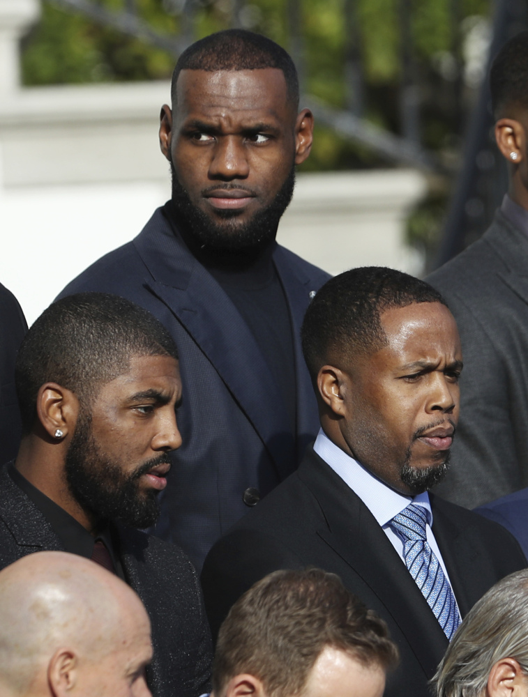 LeBron James, back, and fellow Cleveland Cavaliers are honored in Washington.