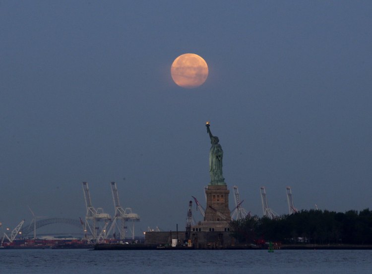 A supermoon rises over the Statue of Liberty in New York in 2013. Monday will have the closest full moon of the year, the closest the moon comes to us in almost 69 years.