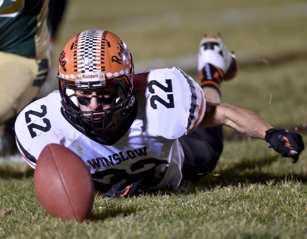 Winslow's Nate St. Amand tries to recover a fumble during the Class C North championship game Friday night against Mt. Desert Island. Top-seeded MDI won the regional title with a 12-7 victory over the two-time defending state champions.
