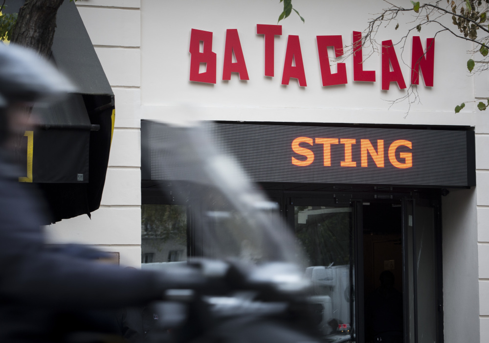 A man rides a scooter past the Bataclan on Saturday.  Proceeds from Sting's concert will go to charities aiding survivors of last year's terror attack.