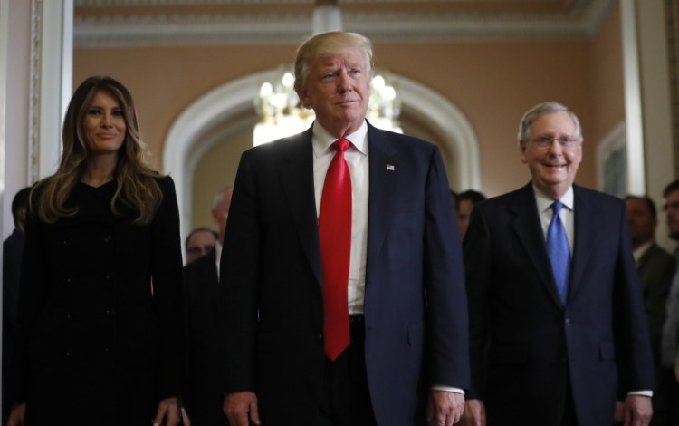 President-elect Donald Trump and his wife Melania walk with Senate Majority Leader Mitch McConnell of Kentucky after at meeting on Capitol Hill on Thursday. Trump has already appointed many wealthy donors to key roles.