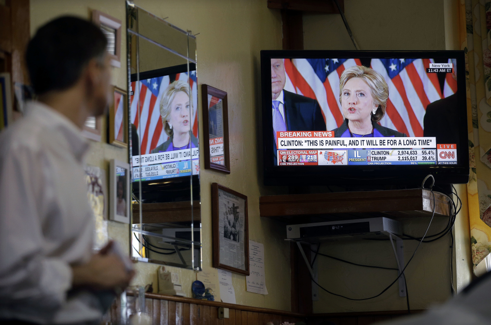 Nestor Papakonstantinou watches the televised concession speech by Democratic presidential candidate Hillary Clinton, Wednesday, Nov. 9, 2016, at the Maugus Restaurant  in Wellesley, Mass. (AP Photo/Steven Senne)