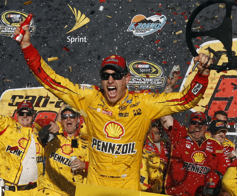 Joey Logano celebrates after he kept his Sprint Cup championship hopes alive with a victory Sunday at Phoenix International Raceway.