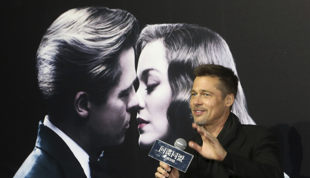 Actor Brad Pitt gestures to his fans as he attends a premiere of his film "Allied" Monday in Shanghai, China.