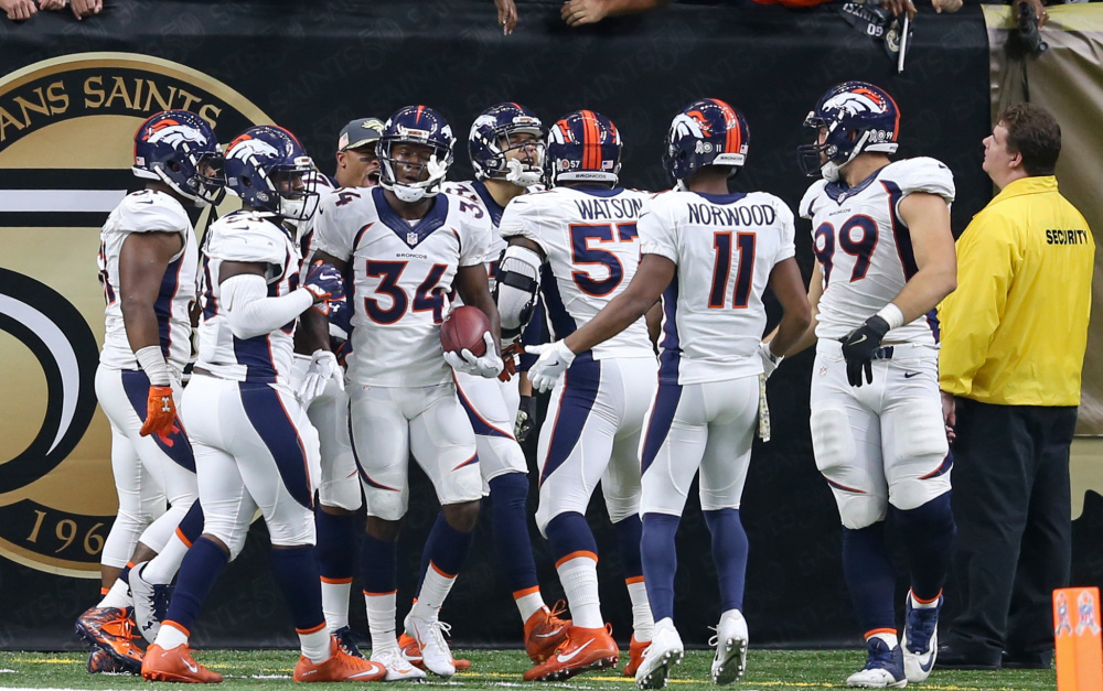 Denver Broncos defensive back Will Parks, 34, celebrates with teammates after scoring the first winning defensive 2-point conversion in NFL history on Sunday .