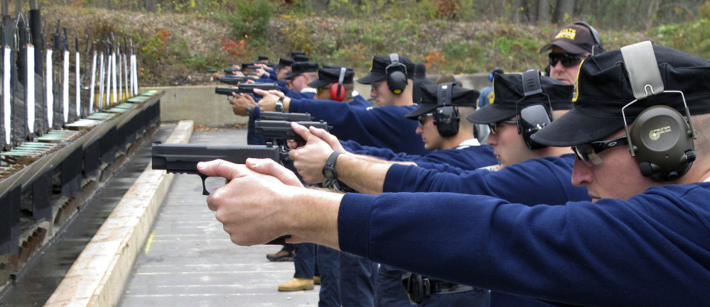 Connecticut State Police recruits practice with their new .45-caliber Sig Sauer pistols during a "dry fire" exercise at the state police firing range in Simsbury, Conn.