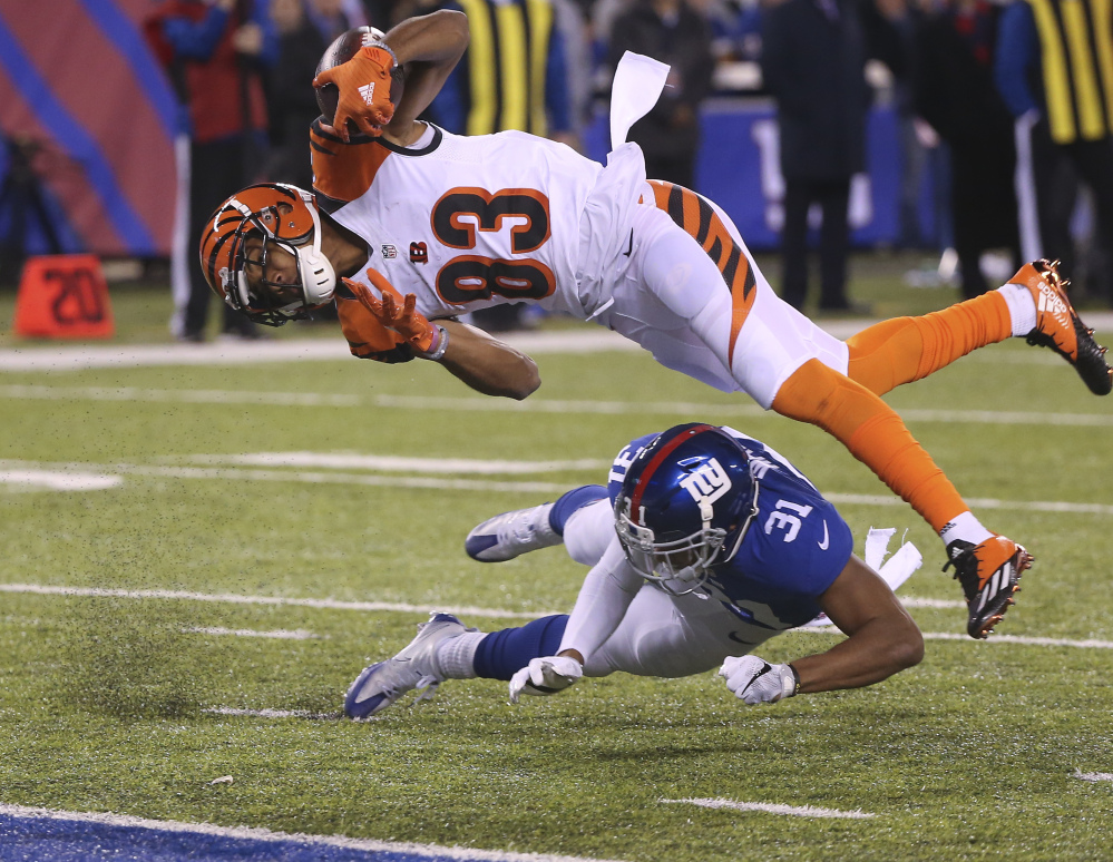 Bengals wide receiver Tyler Boyd dives over Giants cornerback Trevin Wade for a touchdown in the third quarter of New York's 21-20 win Monday in East Rutherford, N.J.