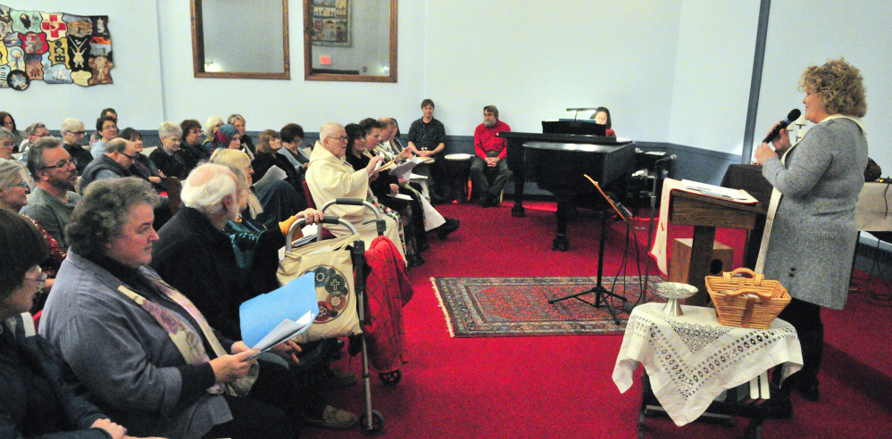 The Rev. Carie Johnsen, of the Unitarian Universalist Community Church, opens a multifaith service of healing, hope and unity Tuesday sponsored by Capital Area Multi-faith Association at Johnsen's church in Augusta.