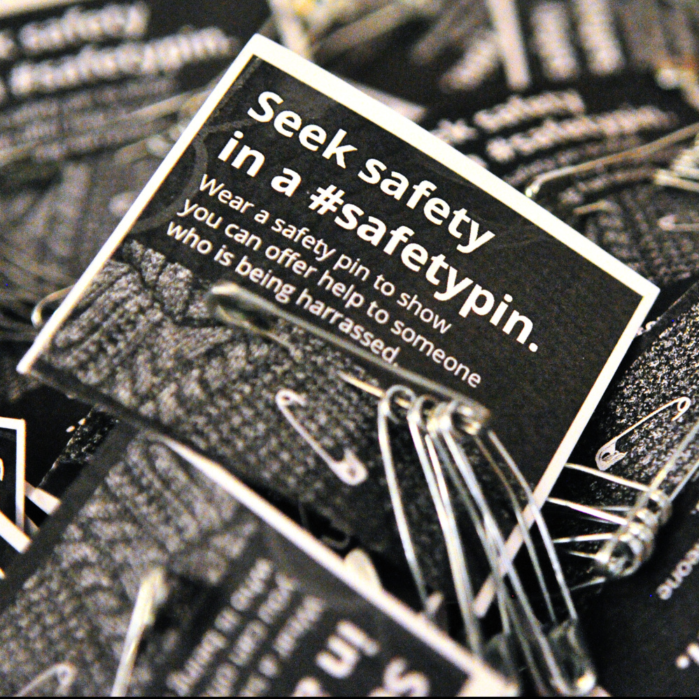 Safety pins in a bowl are available for people to take and wear Tuesday during a multi-faith service of healing, hope and unity sponsored by Capital Area Multi-faith Association at the Unitarian Universalist Community Church in Augusta.
