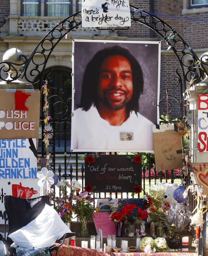 A memorial including a photo of Philando Castile adorns the gate to the Minnesota governor's residence on July 25.