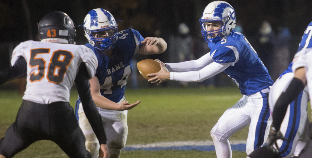Tripp Bush of Kennebunk, right, learned about running an option offense with his dad, an assistant coach, at camps. Now he's the sophomore QB for a team seeking a state title.
