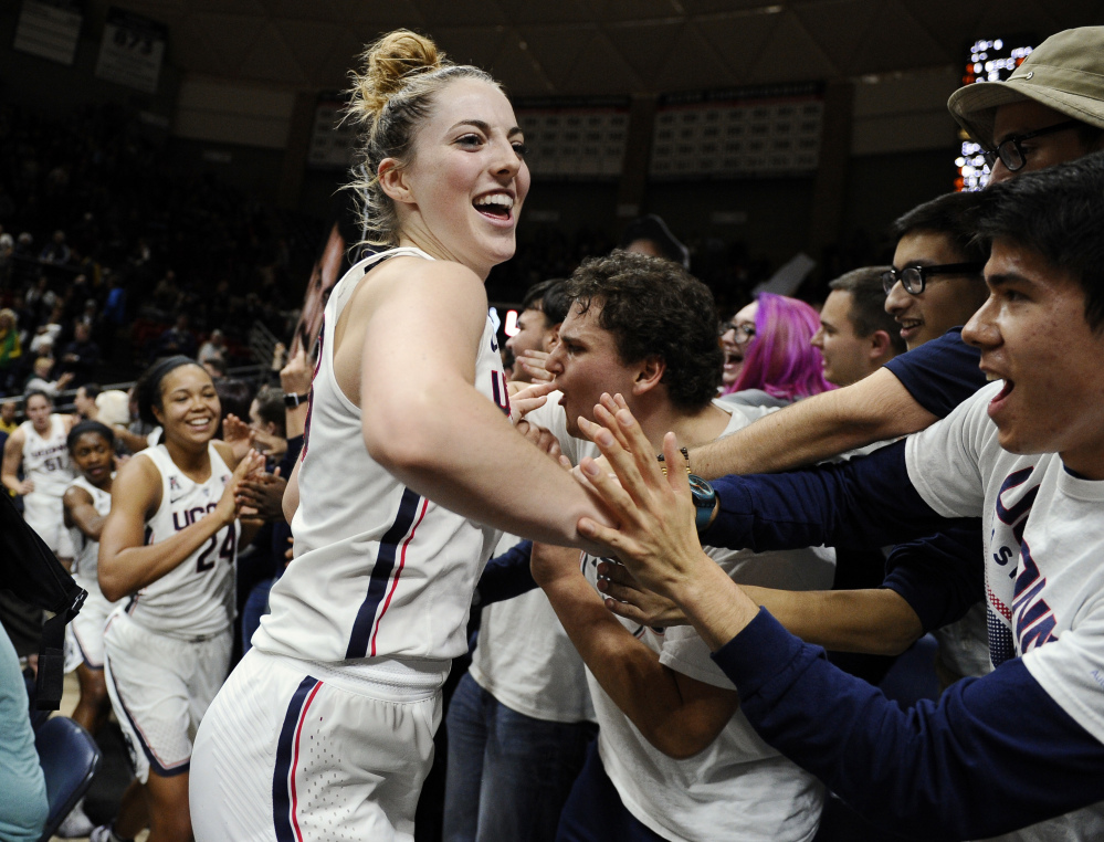 Connecticut's Katie Lou Samuelson and her teammates celebrate their 72-61 win over second-ranked Baylor on Thursday night with UConn students. The third-ranked Huskies have won 77 straight games.