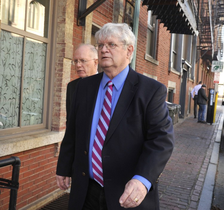 Dr. Joel Sabean, right, and attorney Jay McCloskey walk in the Old Port after his conviction in November.