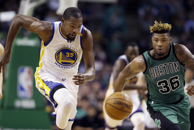 Golden State forward Kevin Durant and Boston guard Marcus Smart chase a loose ball in the third quarter of Friday night's rout by the Warriors in Boston.
