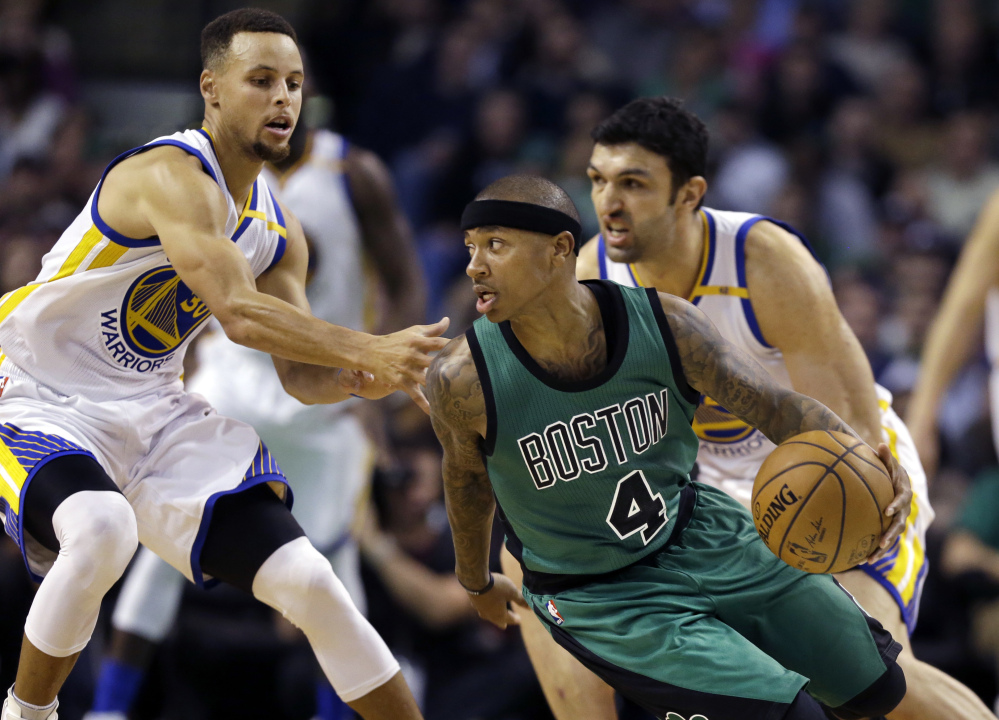 Celtics guard Isaiah Thomas looks for room to drive against Warriors guard Stephen Curry, left, and center Zaza Pachulia in the third quarter.