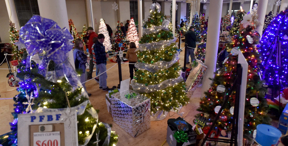 Dozens of Christmas trees are on display Friday at the Sukeforth Family Festival of Trees benefit at the Hathaway Creative Center in Waterville. The festival, in its second year, raises money for Spectrum Generations' Meals on Wheels and Hospice Volunteers of Waterville Area. 