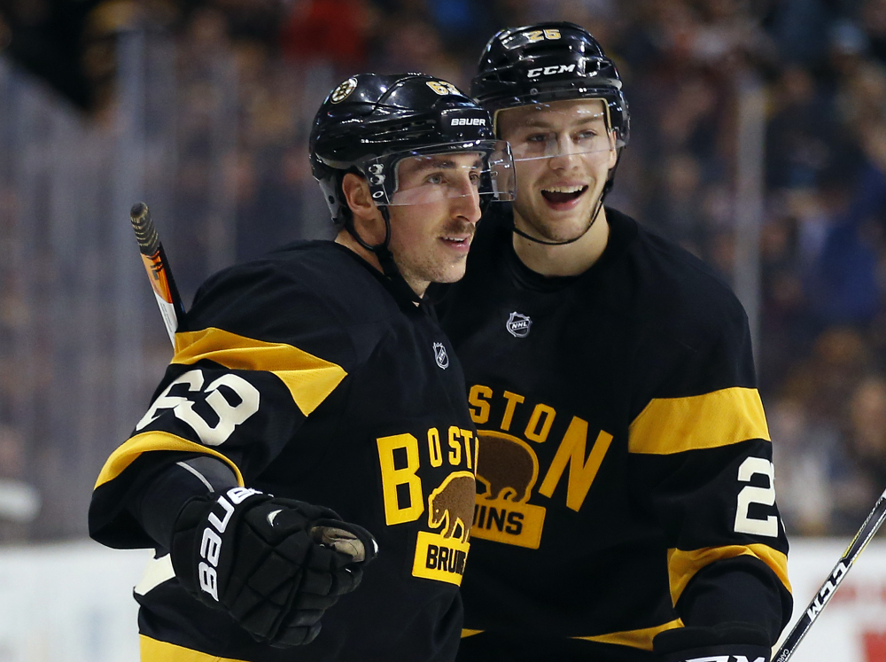 Boston Bruins' Brad Marchand (63) celebrates his goal with Brandon Carlo during the second period of an NHL hockey game against the Winnipeg Jets in Boston on Saturday, Nov. 19, 2016. (Associated Press/Winslow Townson)