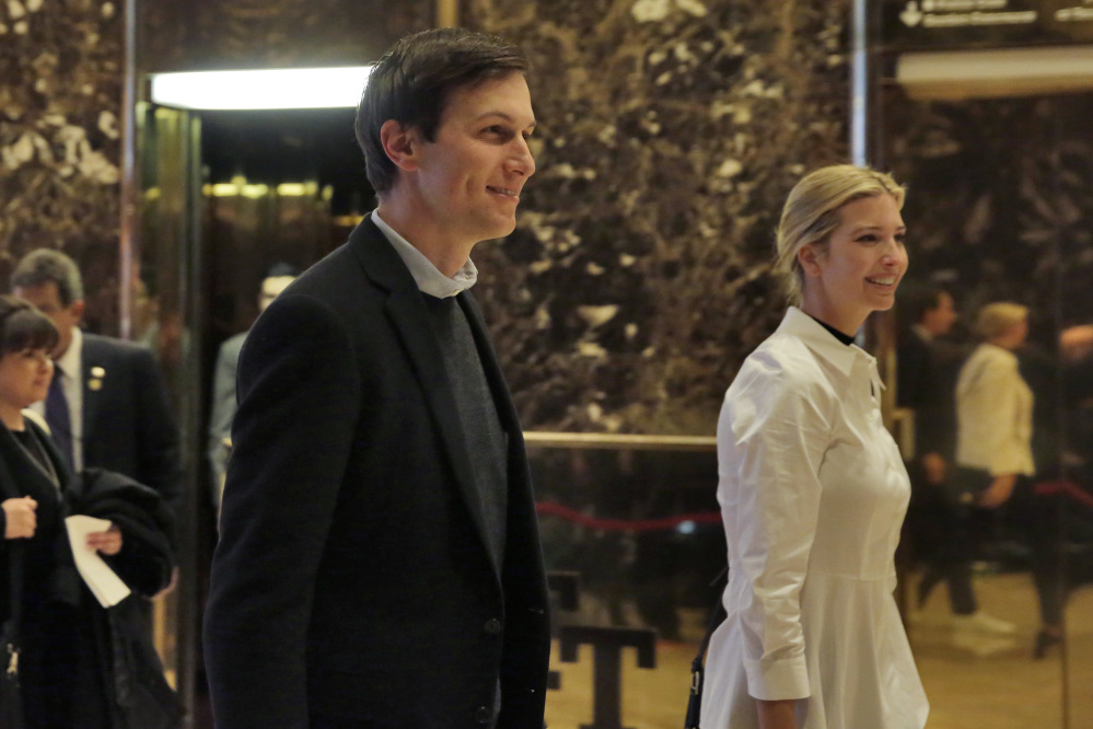 Jared Kushner and his wife, Ivanka Trump, walk through the lobby of Trump Tower in New York on Friday.