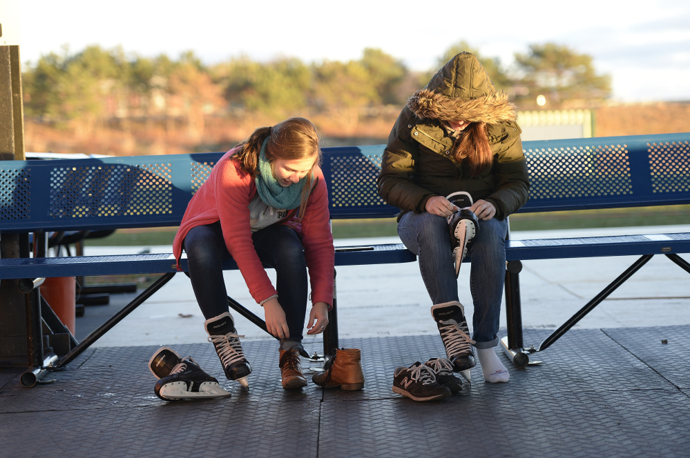 Allison Giannotti of Durham, N.H., and Miranda Foster of New York City prepare to skate Saturday at The Rink at Thompson's Point. The 10,000-square-foot rink on the edge of the Fore River is now in its second year.