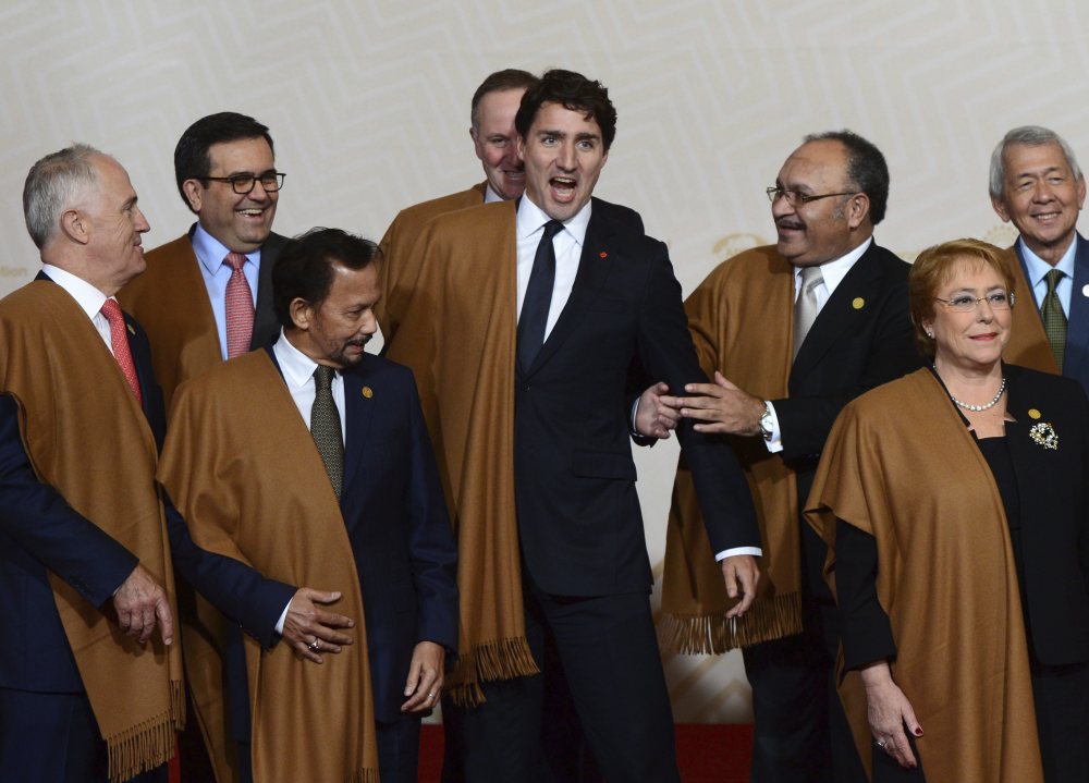 Canadian Prime Minister Justin Trudeau jokes with fellow leaders as they pose for the official photo at the Asia Pacific Economic Cooperation summit in Lima, Peru, on Sunday.