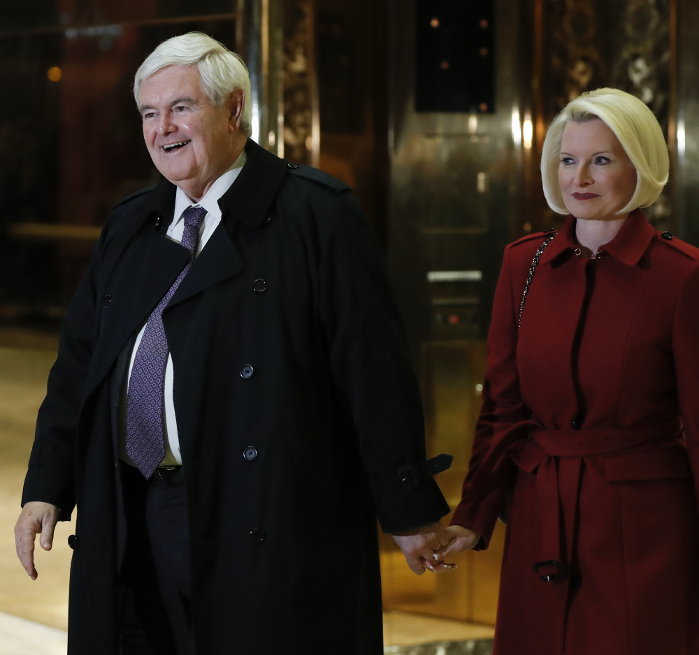 Former House Speaker Newt Gingrich and his wife Callista Gingrich walk through Trump Tower on Monday after meeting with President-elect Donald Trump.