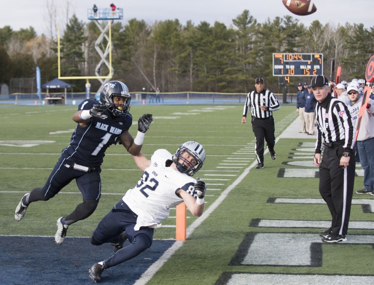 UMaine's Najee Goode chases UNH's Neil O'Connor into the end zone as the ball is overthrown by UNH's Adam Riese during the first half Saturday in Orono. New Hampshire beat Maine to end the Black Bears' season.
Kevin Bennett Photo